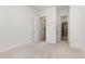 Bright bedroom features neutral carpet, white walls, and doorways to a bathroom and closet at 1417 Westmoreland Dr, Raleigh, NC 27612