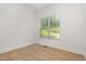 Cozy bedroom featuring hardwood floors, ample natural light from the window, and neutral wall color at 1417 Westmoreland Dr, Raleigh, NC 27612