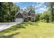 Stunning two-story home with a well-manicured lawn and a long driveway leading to the garage at 1417 Westmoreland Dr, Raleigh, NC 27612