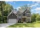 Beautiful two-story home featuring a lush green lawn and mature trees providing ample shade at 1417 Westmoreland Dr, Raleigh, NC 27612