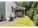 View of the home exterior features an attached screened-in porch with steps leading down to the backyard at 1417 Westmoreland Dr, Raleigh, NC 27612