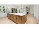 Spacious kitchen island with stone countertop and room to sit with view to the living room at 1417 Westmoreland Dr, Raleigh, NC 27612