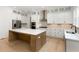 Modern kitchen with white cabinets, center island, stainless steel appliances, and stone backsplash at 1417 Westmoreland Dr, Raleigh, NC 27612