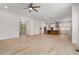 Open-concept living area with hardwood floors, view to kitchen with center island and formal living room at 1417 Westmoreland Dr, Raleigh, NC 27612