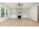 Bright living room featuring hardwood floors, modern fireplace, built-in cabinets, and natural light at 1417 Westmoreland Dr, Raleigh, NC 27612