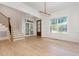 Bright living room with hardwood floors, modern lighting, paneled walls, staircase, and view to the entry at 1417 Westmoreland Dr, Raleigh, NC 27612