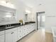 Bathroom boasts dual sinks, granite countertop, white cabinetry and wood look tile flooring at 1425 Sierra Glen Cir, Apex, NC 27502