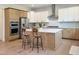 Well-equipped kitchen with stainless steel appliances, hardwood floors, and breakfast bar seating at 1425 Sierra Glen Cir, Apex, NC 27502