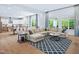 Spacious living room featuring a large sectional couch, hardwood floors and a view of the kitchen at 1425 Sierra Glen Cir, Apex, NC 27502