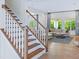 Open-concept living area with stairs, hardwood floors, and ample seating at 1425 Sierra Glen Cir, Apex, NC 27502