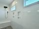 Walk-in shower with white subway tile, rainfall showerhead, bench and mosaic tile floor at 1425 Sierra Glen Cir, Apex, NC 27502