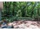 View of a brick patio and a wooded area providing a private and natural setting at 1500 Lakeside Dr, Garner, NC 27529