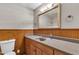 Bathroom featuring wood-paneled walls, a gray countertop, and a framed mirror with vanity lighting at 1500 Lakeside Dr, Garner, NC 27529