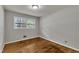 Bedroom features hardwood floors and a large window at 1500 Lakeside Dr, Garner, NC 27529