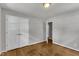 Bedroom features hardwood floors, a double door closet, and neutral walls at 1500 Lakeside Dr, Garner, NC 27529