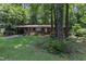Charming brick home featuring a well-maintained lawn and mature trees, providing a serene and inviting curb appeal at 1500 Lakeside Dr, Garner, NC 27529