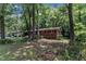 A cozy brick home surrounded by mature trees and a grassy lawn, creating a peaceful setting at 1500 Lakeside Dr, Garner, NC 27529