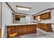 Spacious kitchen features a center island, light countertops, and wood cabinets at 1500 Lakeside Dr, Garner, NC 27529
