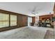 Spacious living room featuring wood paneling, a brick fireplace, and large windows for ample natural light at 1500 Lakeside Dr, Garner, NC 27529