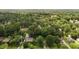 An aerial view of a quiet, secluded neighborhood surrounded by lush greenery and mature trees at 1542 W Davis St, Burlington, NC 27215