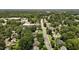 An aerial view showing homes, tree lined streets and community buildings in a tranquil neighborhood setting at 1542 W Davis St, Burlington, NC 27215