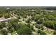 An aerial perspective highlights a quiet residential street nestled among mature trees and well-maintained homes at 1542 W Davis St, Burlington, NC 27215
