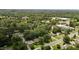 A serene aerial view showcasing a neighborhood with tree-lined streets, community buildings and lush greenery at 1542 W Davis St, Burlington, NC 27215