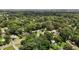 This aerial shot captures a peaceful residential area surrounded by a lush, green canopy of mature trees at 1542 W Davis St, Burlington, NC 27215