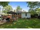 Spacious backyard with a charming brick patio, outdoor cooking area, and mature trees at 1542 W Davis St, Burlington, NC 27215