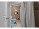 Clean bathroom featuring a shower with curtain, toilet, and built-in storage at 1542 W Davis St, Burlington, NC 27215