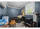 Cozy bedroom with blue paneled walls and a window providing natural light at 1542 W Davis St, Burlington, NC 27215