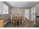 Cozy dining area with natural light and views leading seamlessly to kitchen at 1542 W Davis St, Burlington, NC 27215