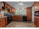 This kitchen features stainless steel appliances, wood cabinets, granite countertops, and tile backsplash at 1542 W Davis St, Burlington, NC 27215