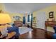 Cozy living room boasts hardwood floors, piano, and comfortable blue seating area at 1542 W Davis St, Burlington, NC 27215