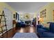 Inviting living room featuring hardwood floors, a fireplace, and comfortable blue seating at 1542 W Davis St, Burlington, NC 27215