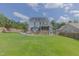 Backyard view of the home featuring a large deck, gazebo, and lush green lawn with privacy fence at 168 Melody Ln, Cameron, NC 28326