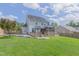 Backyard view of the home featuring a large deck, gazebo, and lush green lawn with privacy fence at 168 Melody Ln, Cameron, NC 28326