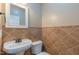 Stylish powder room featuring tile walls and a decorative mirror at 168 Melody Ln, Cameron, NC 28326