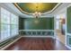 Bright dining room featuring natural light, decorative moldings, hardwood floors, and an elegant chandelier at 168 Melody Ln, Cameron, NC 28326