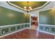 Elegant dining room with decorative molding, hardwood floors and a chandelier lighting at 168 Melody Ln, Cameron, NC 28326