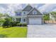 Charming two-story home with stone accents and a spacious driveway showcasing curb appeal at 168 Melody Ln, Cameron, NC 28326
