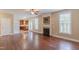 Cozy living room featuring a fireplace, hardwood floors, and open access to the kitchen at 168 Melody Ln, Cameron, NC 28326