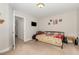 This bedroom has a carpeted floor, neutral-colored walls, twin bed, and an open doorway with a TV on the wall at 1726 Rapids Ct, Franklinton, NC 27525