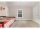 Simple bedroom with neutral walls, carpet, and a twin bed with a sports themed blanket and natural light at 1726 Rapids Ct, Franklinton, NC 27525