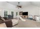 Spacious carpeted bonus room with high ceilings, a ceiling fan, furniture, TV, slide, and natural light at 1726 Rapids Ct, Franklinton, NC 27525