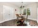 Cozy dining area features a chandelier, dark wood floors, and a window with natural light at 1726 Rapids Ct, Franklinton, NC 27525