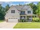 Charming two-story home with a well-maintained lawn, attached garage and inviting front porch at 1726 Rapids Ct, Franklinton, NC 27525