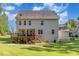 Home's exterior back view includes the 2nd story deck, lawn, and detached garage at 1726 Rapids Ct, Franklinton, NC 27525