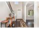 Bright foyer with hardwood floors, staircase, and decorative console table at 1726 Rapids Ct, Franklinton, NC 27525