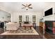 Cozy living room featuring hardwood floors, fireplace, and comfortable seating area at 1726 Rapids Ct, Franklinton, NC 27525